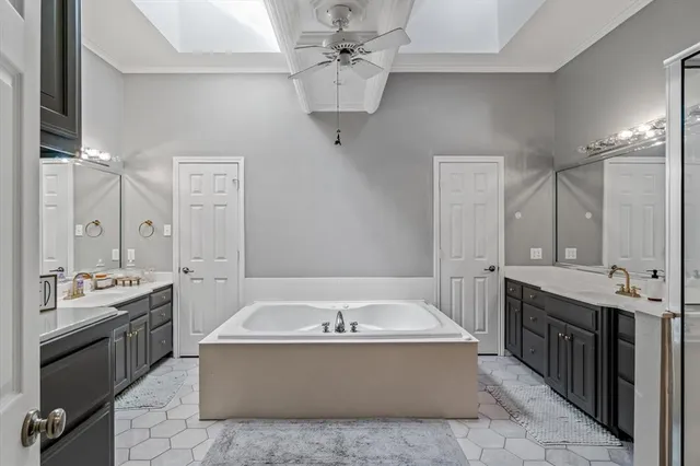 a spacious bathroom with a tub sink shower and mirror