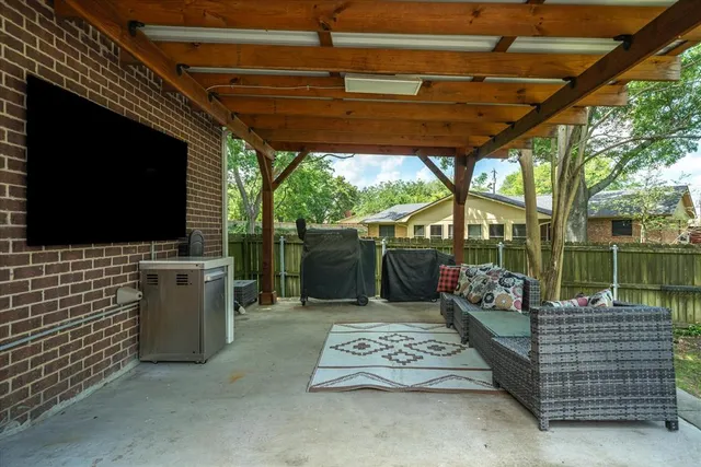 a view of outdoor sitting area with furniture and garden view