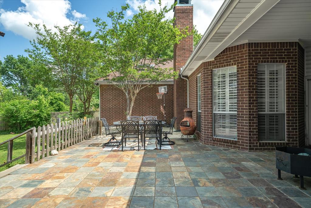 1807 Mill Creek Road Canton, TX 75103 - Photo 27 of 33 a view of a patio with table and chairs and wooden fence
