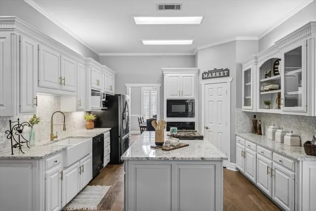 a kitchen with cabinets appliances a sink and a counter top space