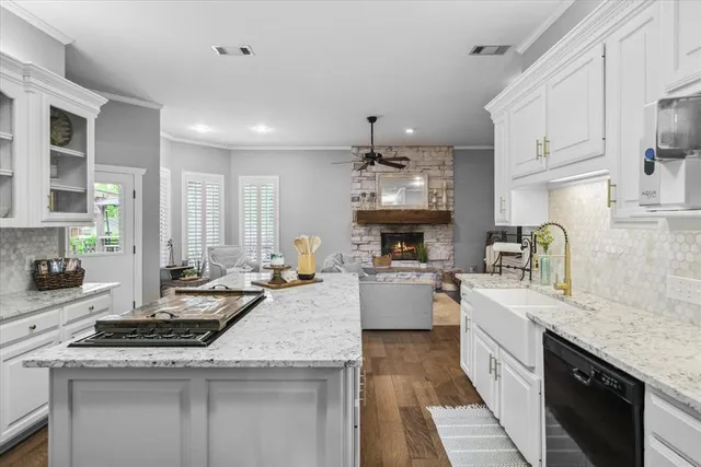 a kitchen with a sink stove and cabinets