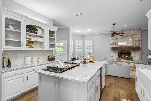 a kitchen with a sink stove and cabinets