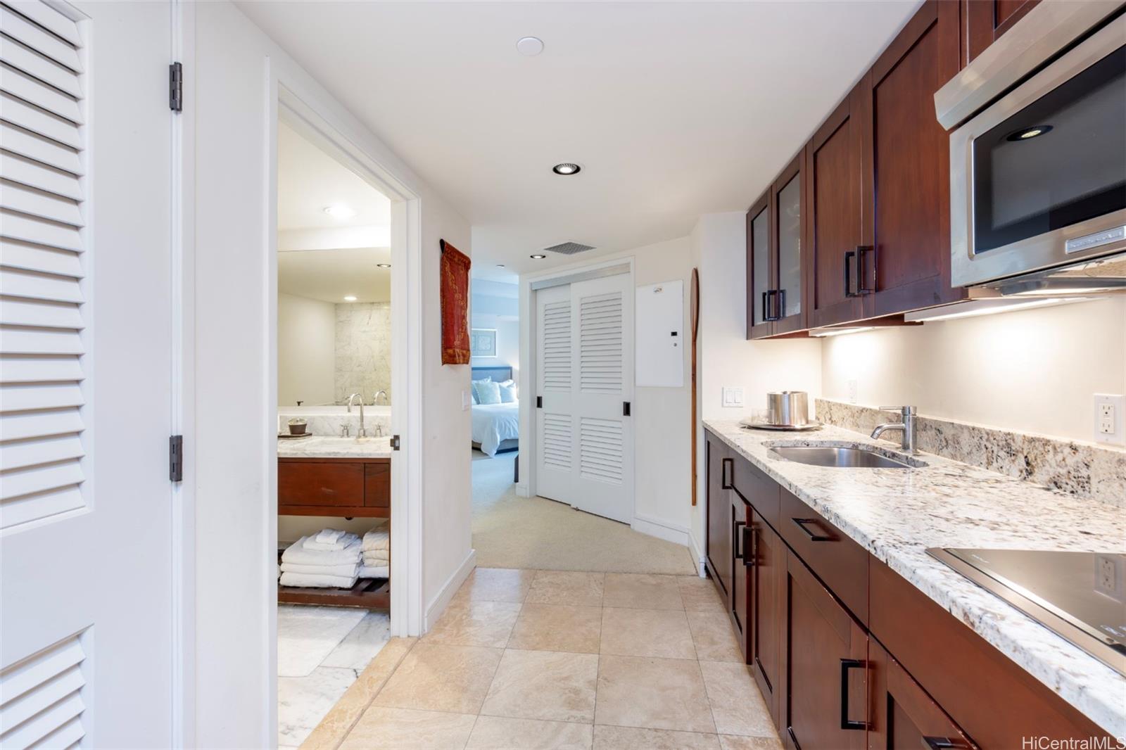223 Saratoga Road, Unit 810 Honolulu, HI 96815 - Photo 11 of 24 a kitchen with a sink and a stove top oven