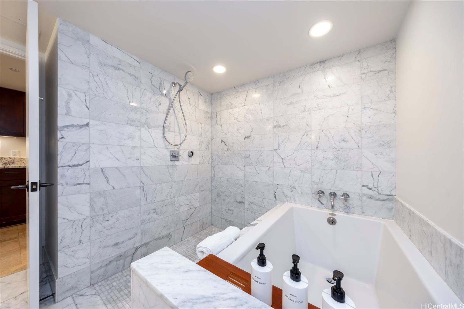 223 Saratoga Road, Unit 810 Honolulu, HI 96815 - Photo 13 of 24 a bathroom with a tub and a shower