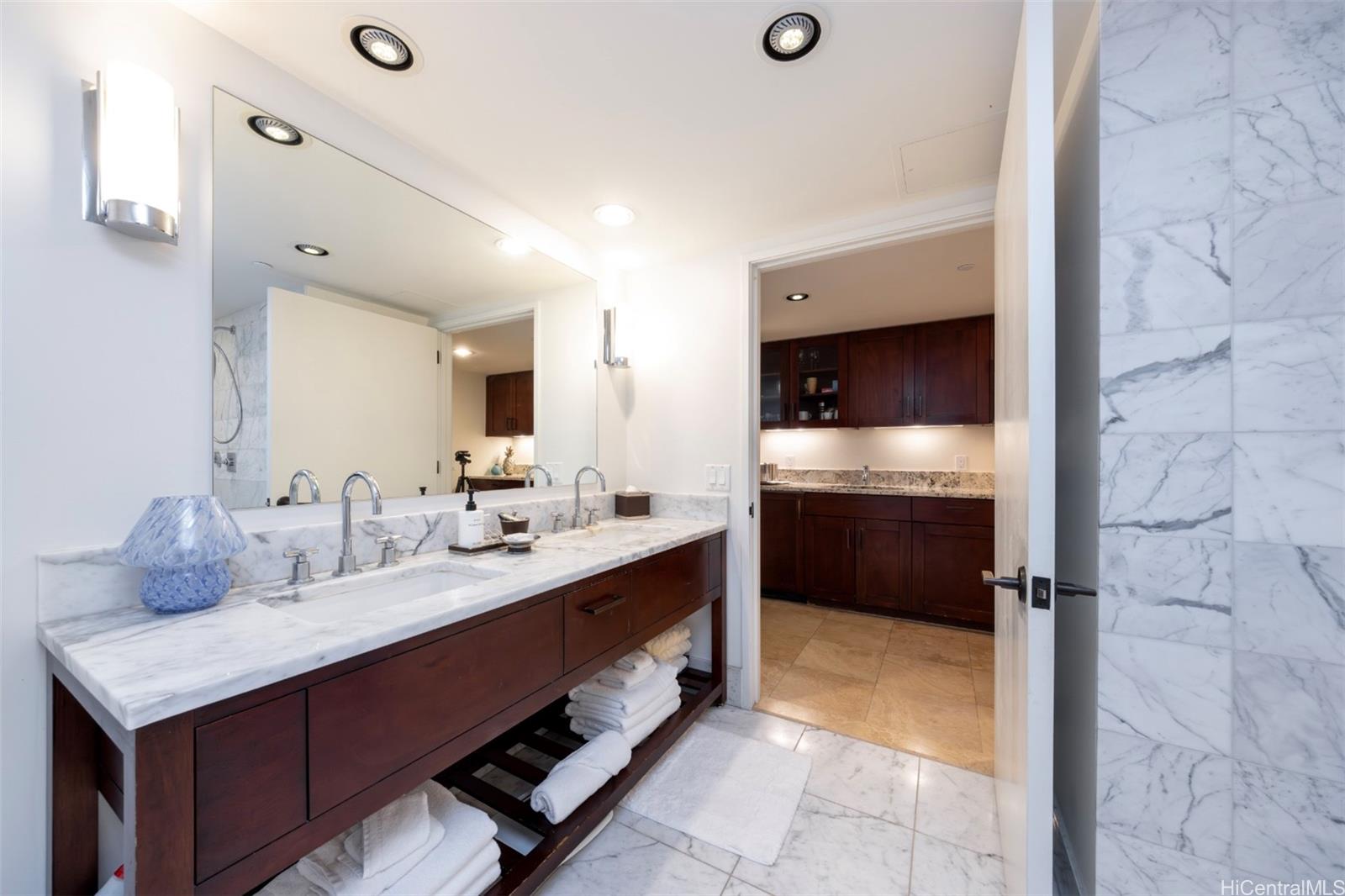 223 Saratoga Road, Unit 810 Honolulu, HI 96815 - Photo 16 of 24 a bathroom with a sink double vanity and a mirror