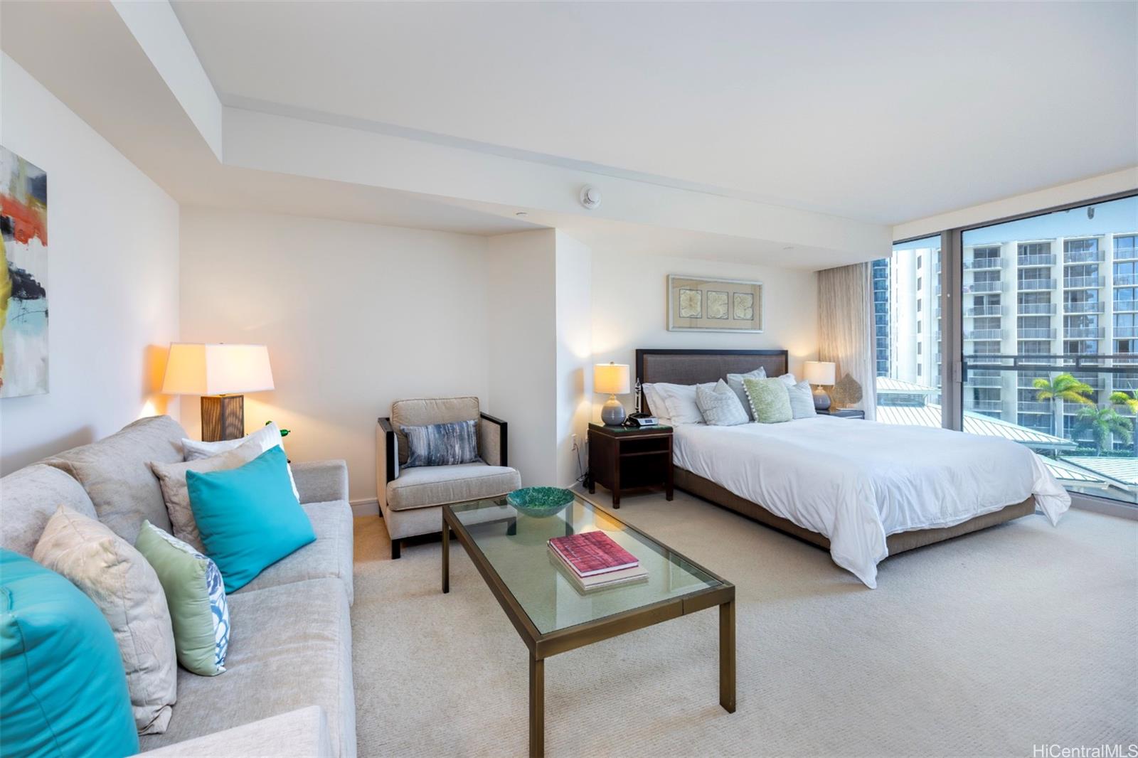 223 Saratoga Road, Unit 810 Honolulu, HI 96815 - Photo 17 of 24 a bedroom with a bed a table and window