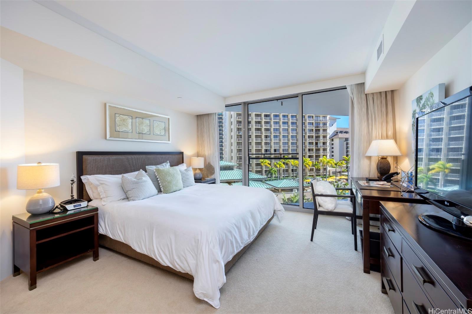 223 Saratoga Road, Unit 810 Honolulu, HI 96815 - Photo 4 of 24 a bedroom with a bed and a night stand