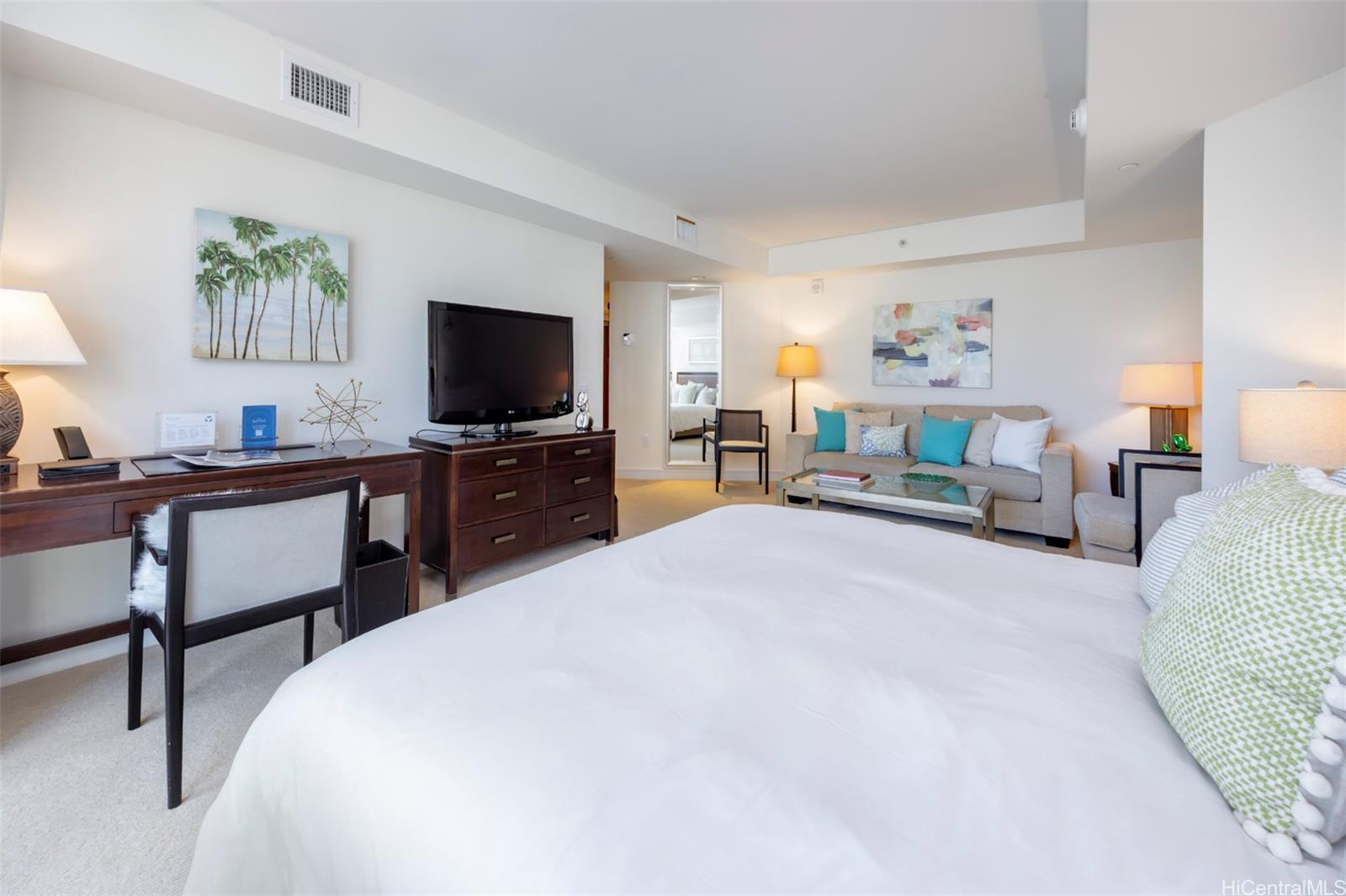 223 Saratoga Road, Unit 810 Honolulu, HI 96815 - Photo 5 of 24 a bedroom with a bed and a flat screen tv