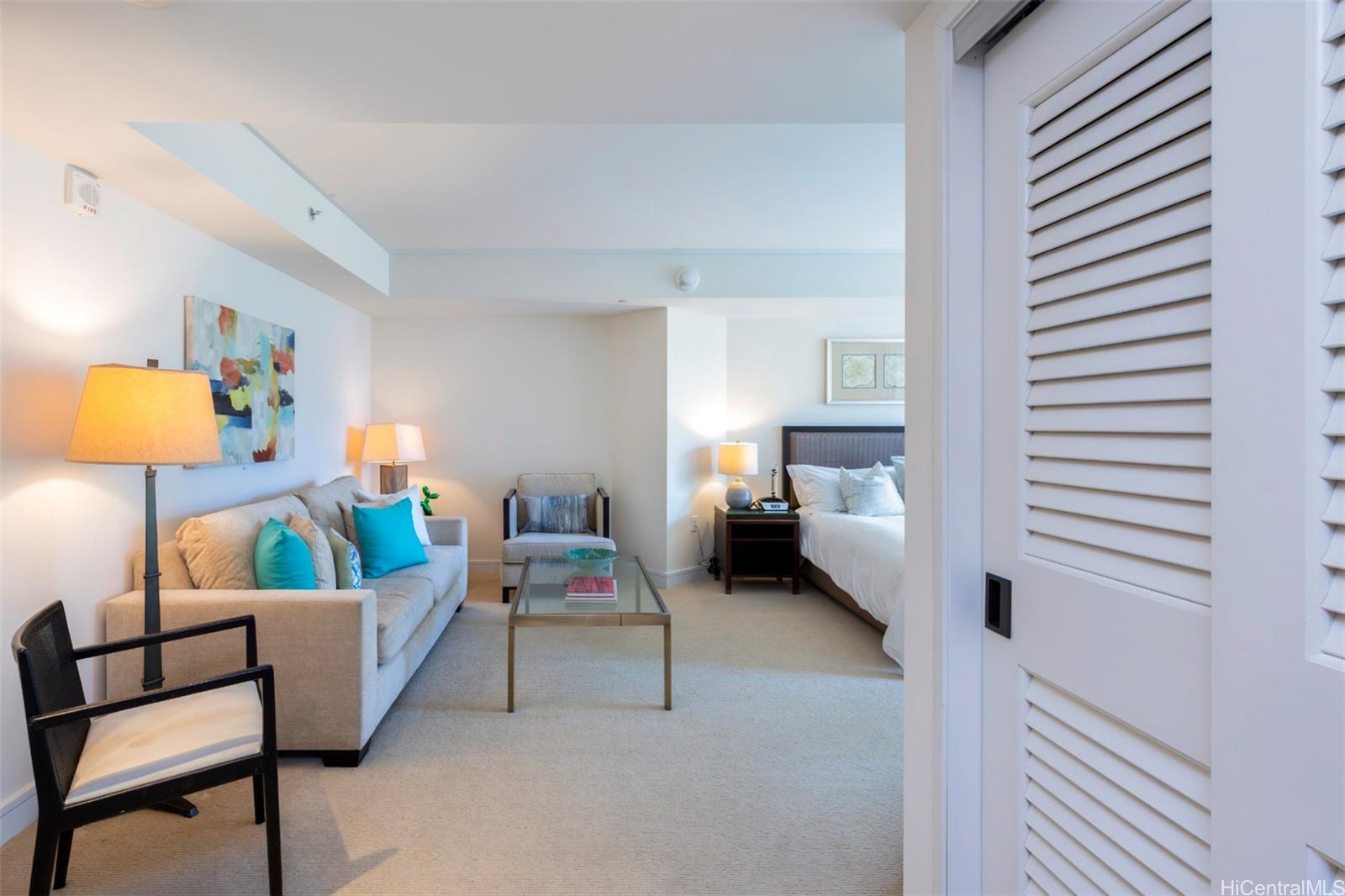 223 Saratoga Road, Unit 810 Honolulu, HI 96815 - Photo 8 of 24 a living room with furniture and a lamp