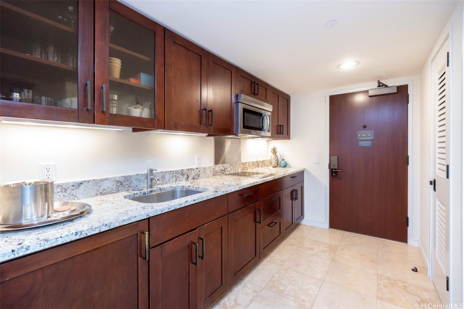 223 Saratoga Road, Unit 810 Honolulu, HI 96815 - Photo 9 of 24 a spacious bathroom with a granite countertop double vanity sink and mirror