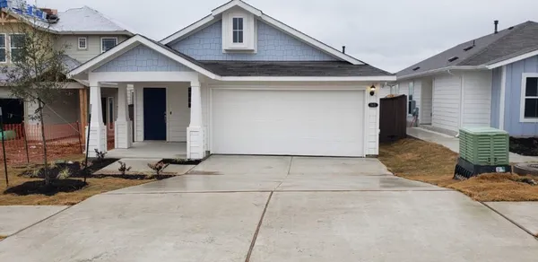 a front view of a house with sitting area