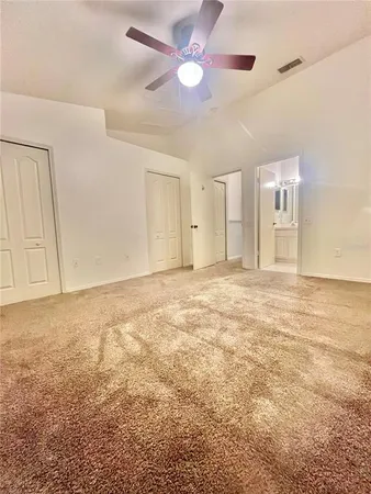 a view of an empty room with a ceiling fan
