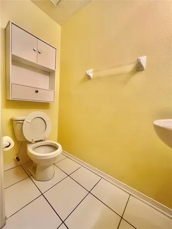 a bathroom with a toilet and a mirror