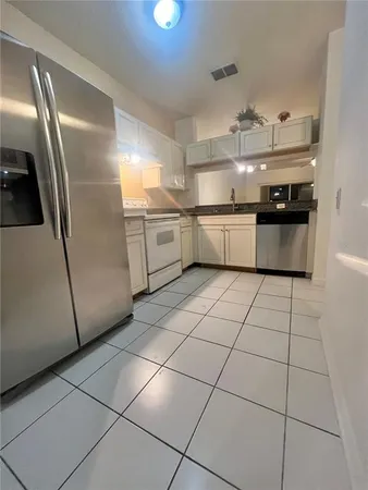 a kitchen with stainless steel appliances a sink and a counter top space