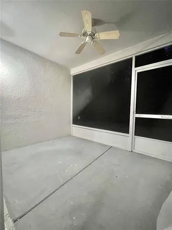a view of an empty room with a ceiling fan