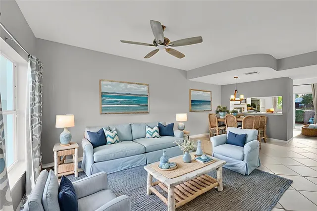 a living room with furniture and a ceiling fan