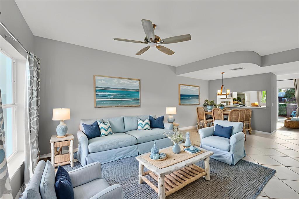 a living room with furniture and a ceiling fan