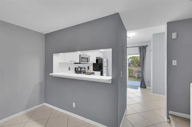 a kitchen with stainless steel appliances a sink and cabinets