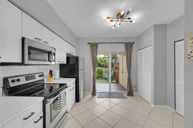 a kitchen with stainless steel appliances a stove a refrigerator and a sink