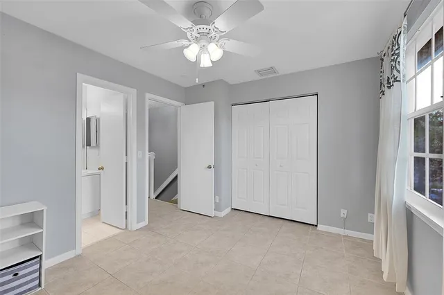 a view of a room with a ceiling fan and bathroom