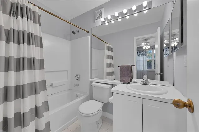 a bathroom with a sink toilet a mirror a bathtub and shower