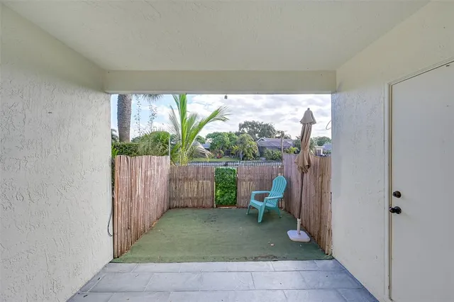 a view of a backyard with garden and patio