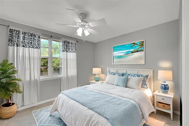 a bedroom with a large bed and a potted plant