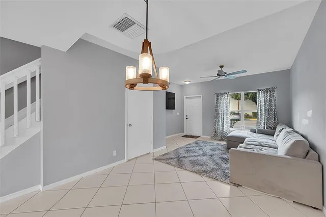 a living room with furniture and a chandelier