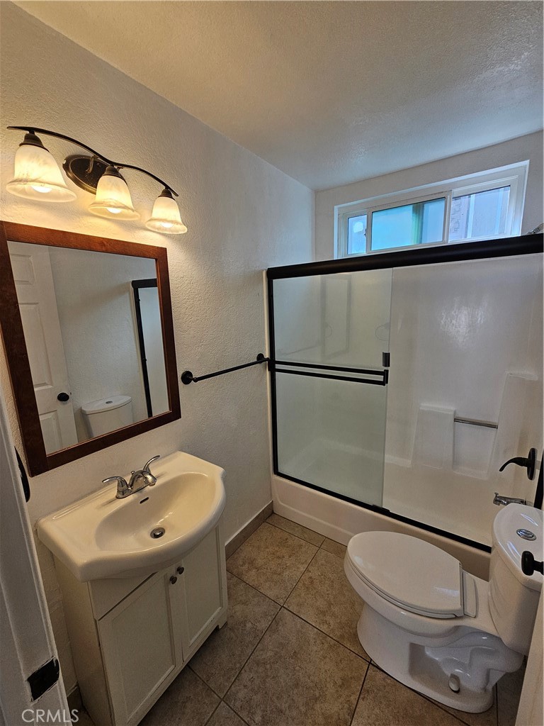 10037 Samoa Avenue, Unit 6 Tujunga, CA 91042 - Photo 6 of 7 a bathroom with a sink toilet and mirror