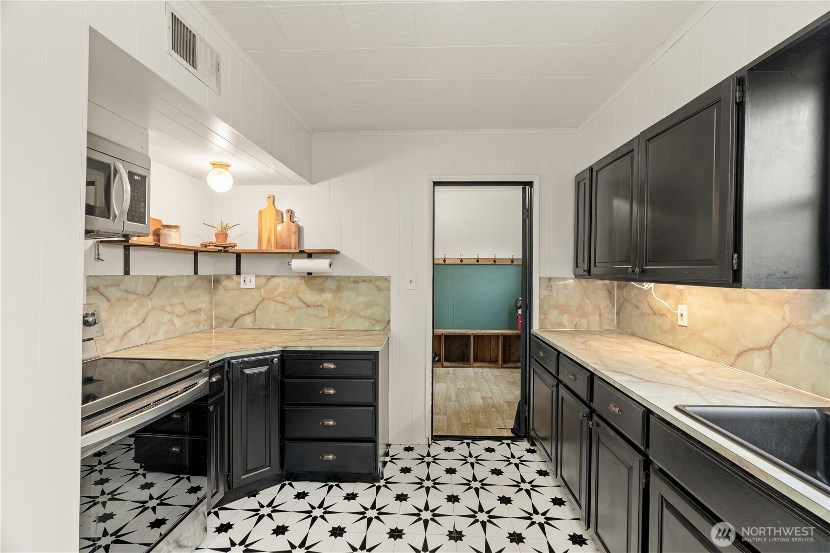 515 5th Street Hoquiam, WA 98550 - Photo 11 of 34 a kitchen with stainless steel appliances granite countertop a sink and a stove