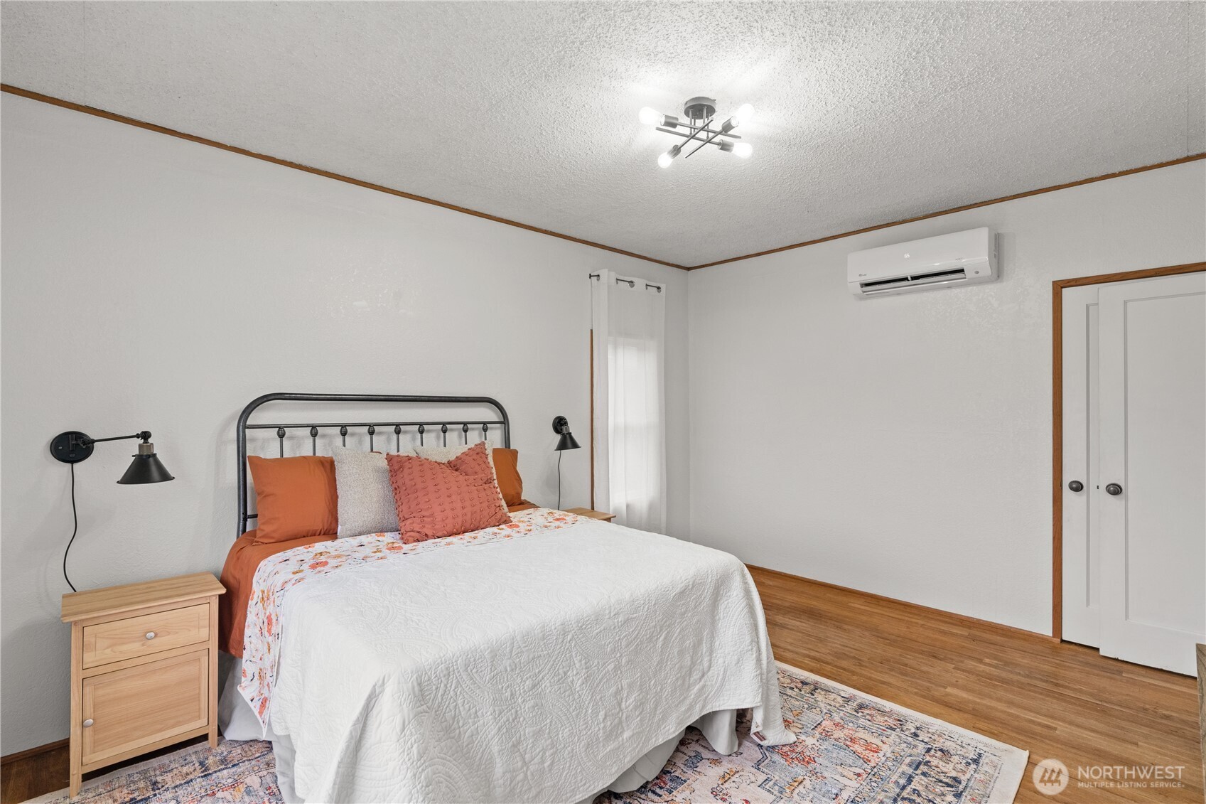 515 5th Street Hoquiam, WA 98550 - Photo 24 of 34 a bedroom with a bed and a chandelier