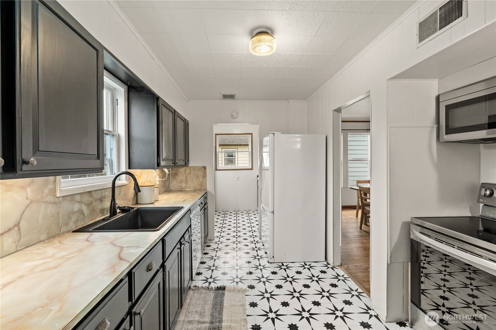515 5th Street Hoquiam, WA 98550 - Photo 10 of 34 a kitchen with a sink a stove and refrigerator