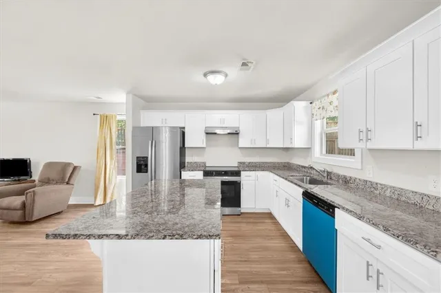 a large kitchen with granite countertop lots of counter top space