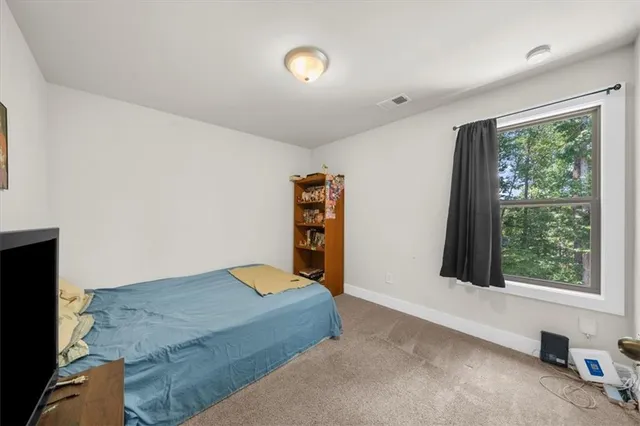 a bedroom with a bed and a large window