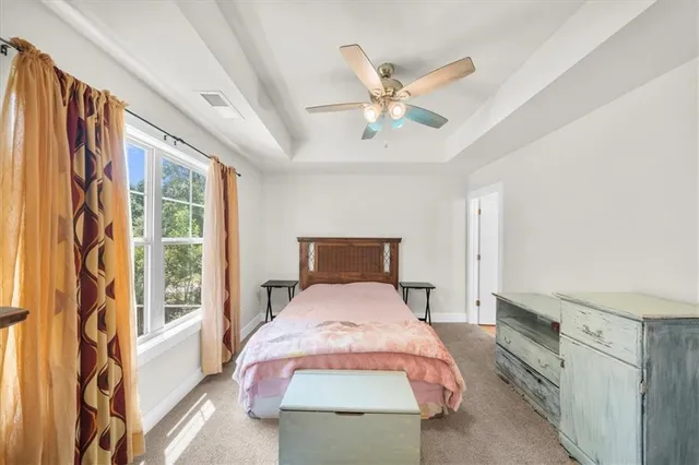 a bedroom with a large bed and a window