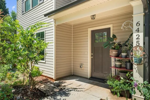 a view of a house with potted plants