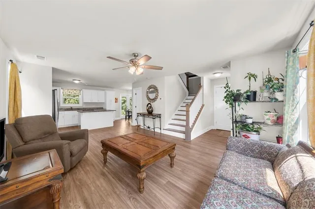 a living room with furniture and wooden floor