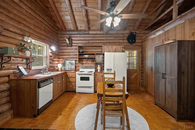 a kitchen with refrigerator a stove and chairs