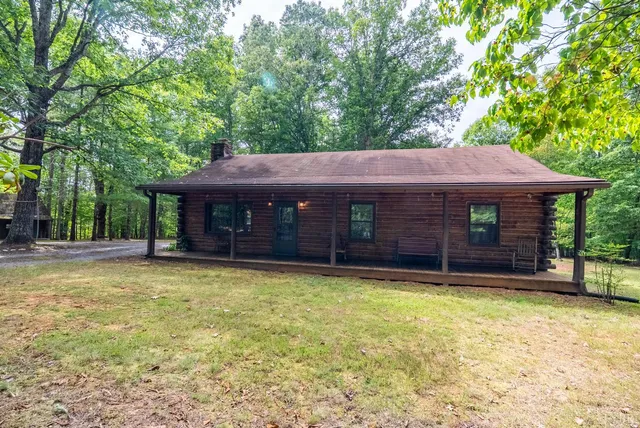a view of a house with a yard and tree