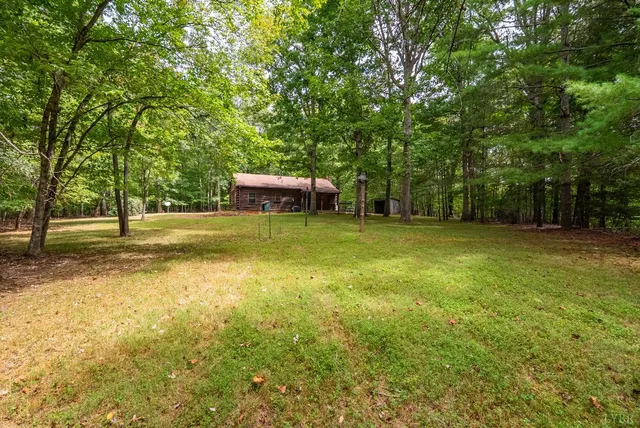 a backyard of a house with lots of green space