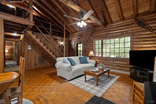 a living room with furniture a flat screen tv and a table