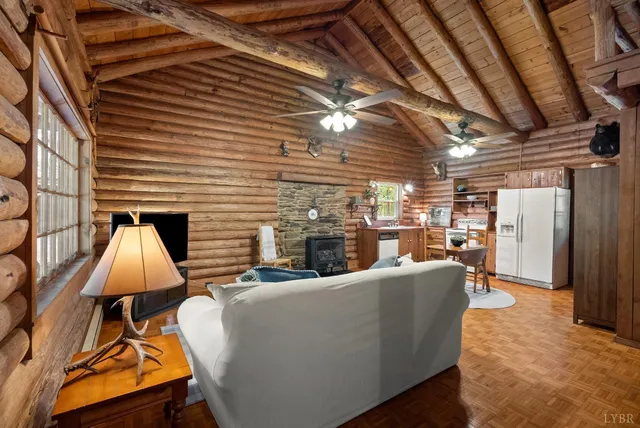 a living room with furniture and a ceiling fan