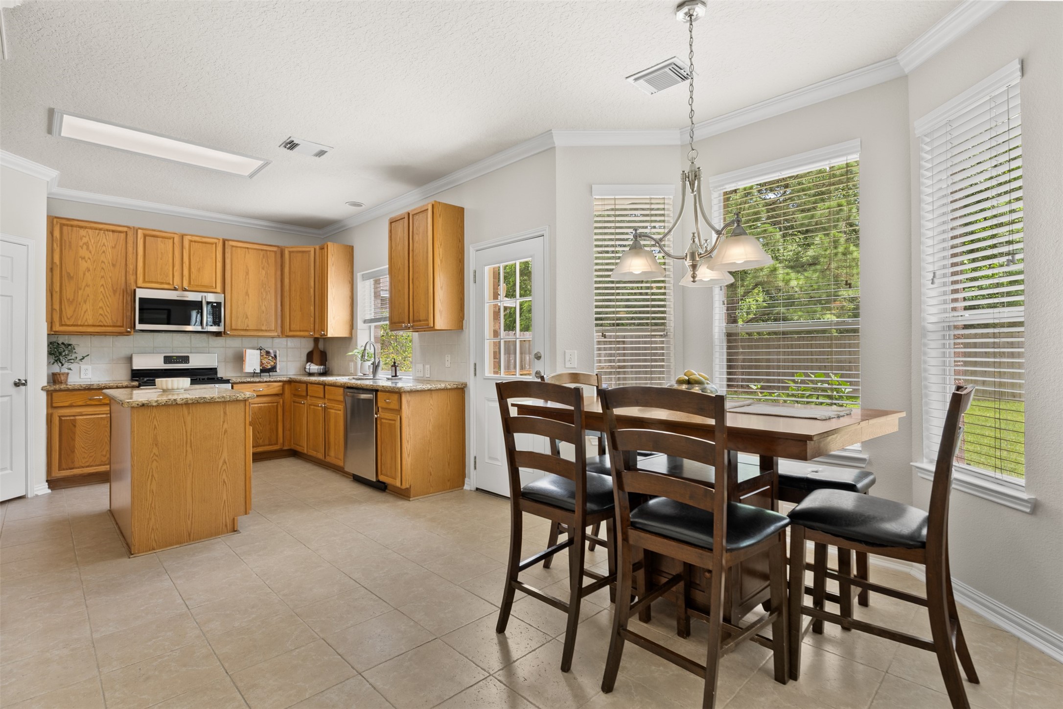 2219 Louetta Brook Lane Spring, TX 77388 - Photo 13 of 34 Kitchen featuring granite countertops, stainless steel appliances, and center island.