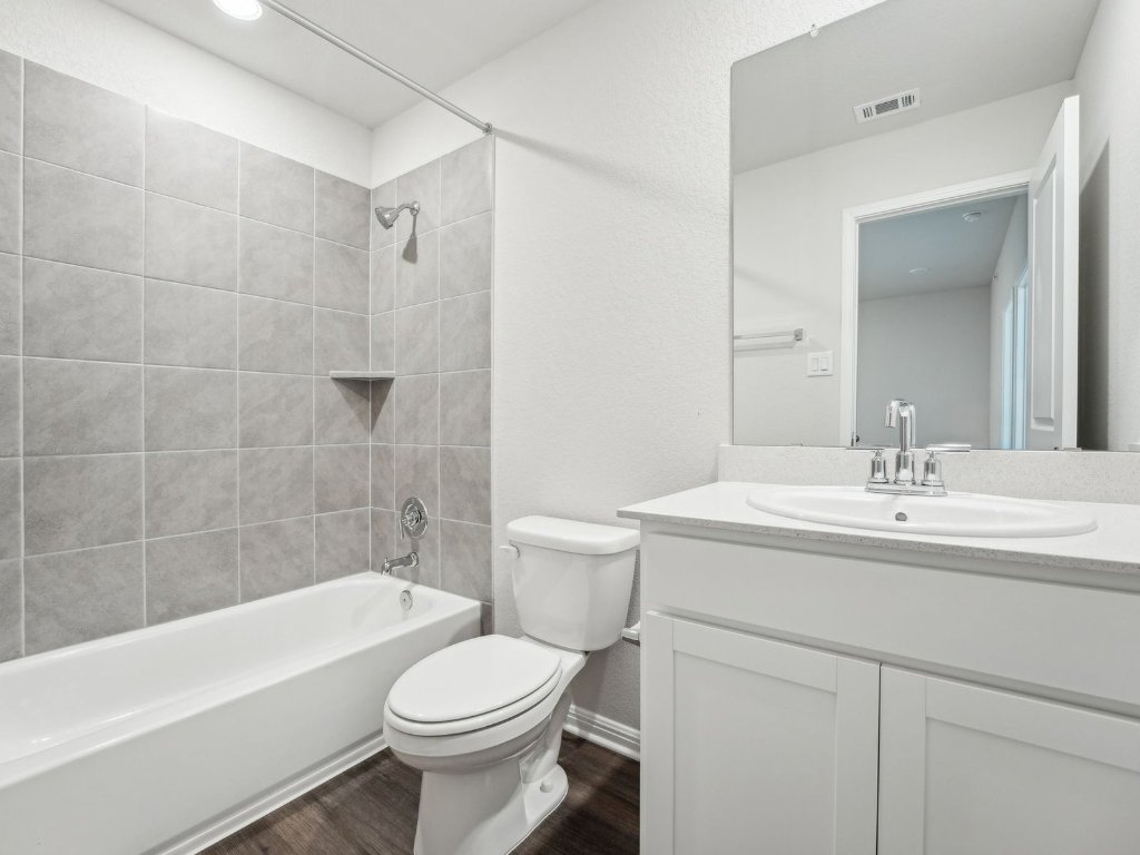 165 Calcite Road, Unit 2 Kyle, TX 78640 - Photo 11 of 14 a bathroom with a sink a toilet and shower