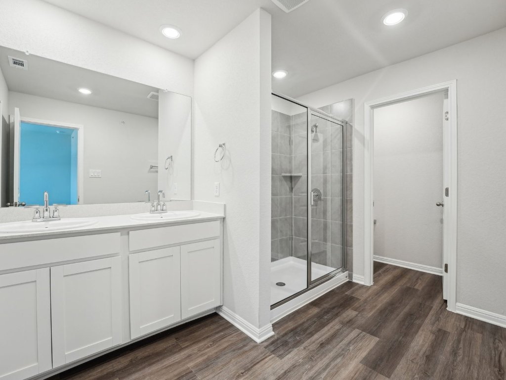 165 Calcite Road, Unit 2 Kyle, TX 78640 - Photo 7 of 14 a bathroom with a shower sink and mirror