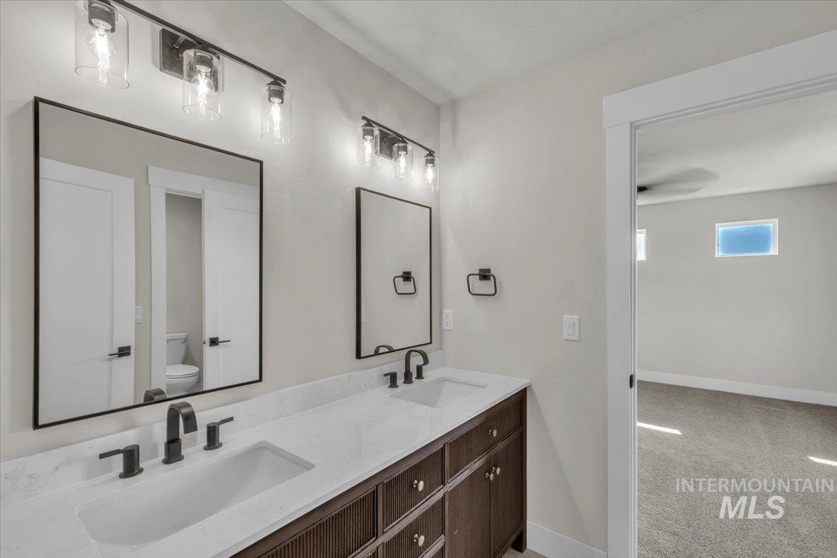 72 South Ravine Way Nampa, ID 83687 - Photo 24 of 48 Spacious walk-in shower featuring a recessed ceiling light, matte black fixtures, a built-in shower niche, and a combination of grey subway-style and light-toned large format tile