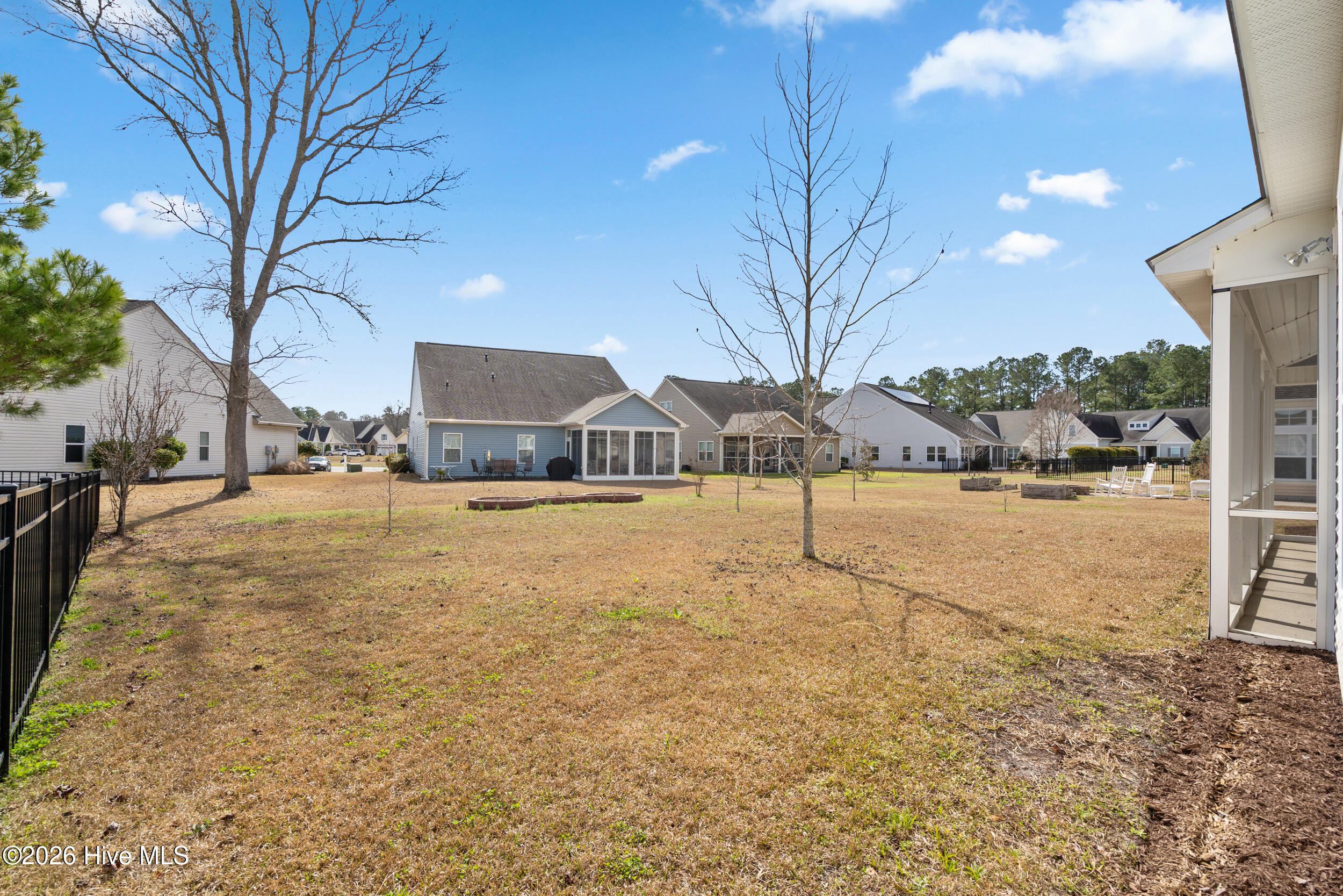 1013 Meadowlands Trail Calabash, NC 28467 - Photo 27 of 41 Step into the backyard and enjoy sitting on the covered screened-in porch