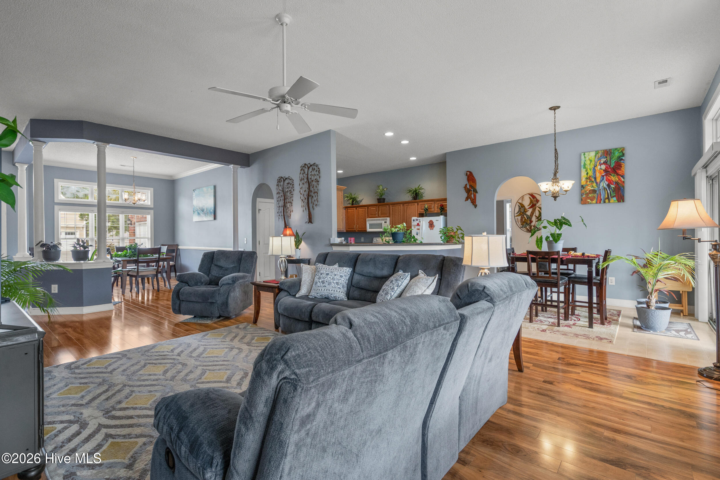 1013 Meadowlands Trail Calabash, NC 28467 - Photo 9 of 41 The living area features high ceilings, high gloss floors, and a ceiling fan.