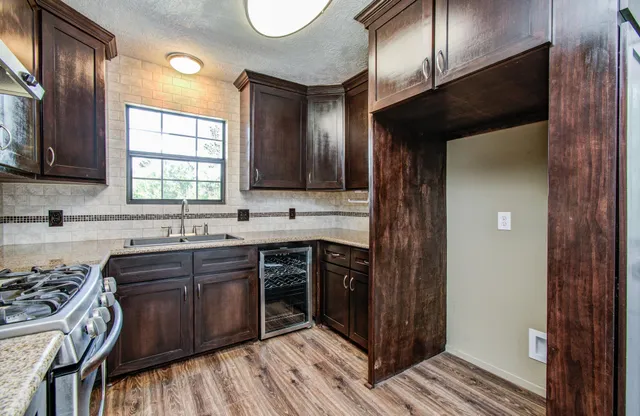a kitchen with wooden cabinets and a sink