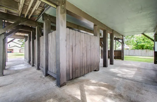 a view of a house with a yard deck and sitting area